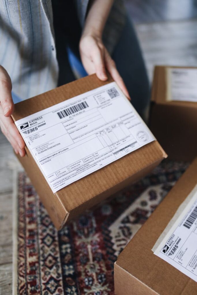 pexels photo 4440798 Close-up of hands holding a package with a visible shipping label, perfect for delivery themes.